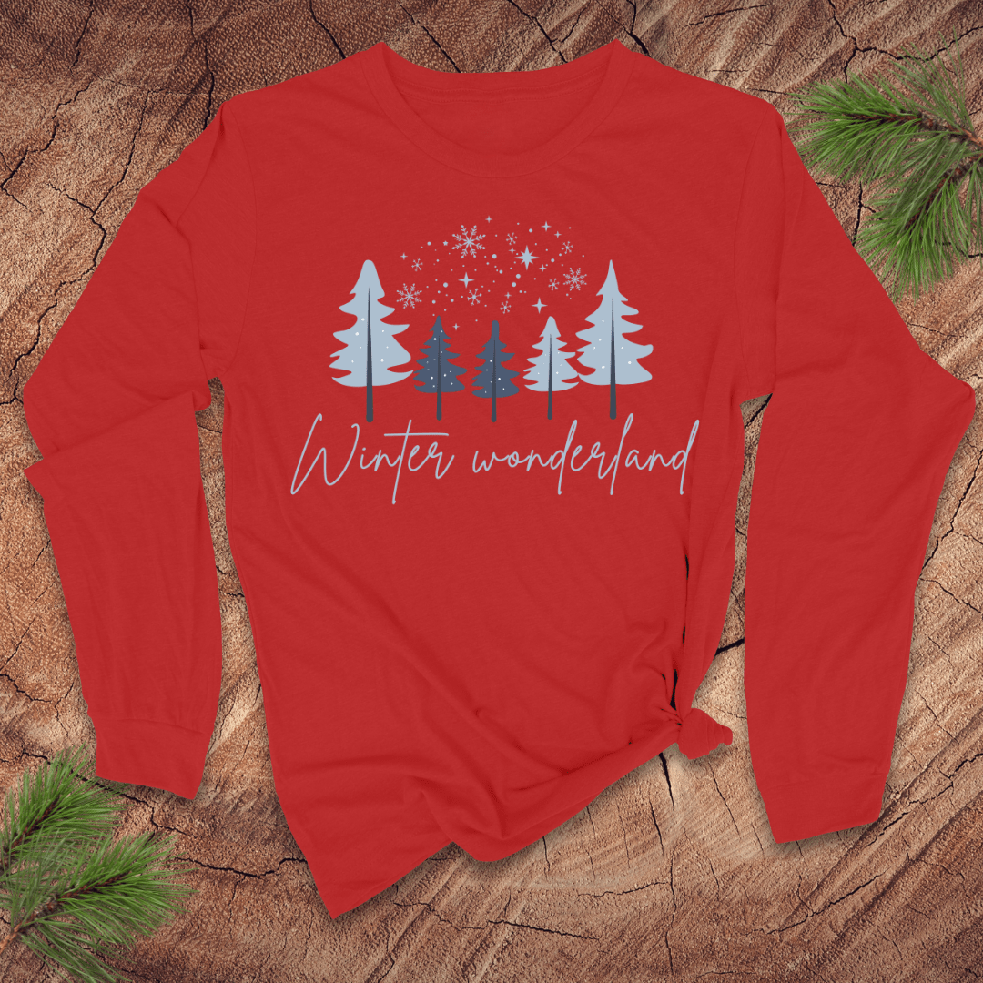 Red long-sleeve shirt with 'Winter wonderland' text and tree design on a wooden surface.