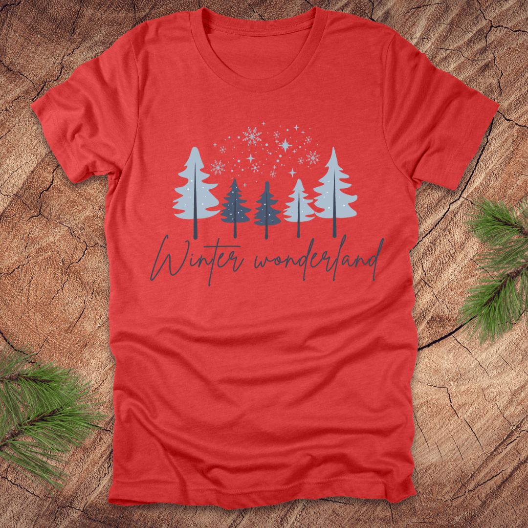 Red t-shirt with 'Winter wonderland' text and trees with snow design on a wooden surface