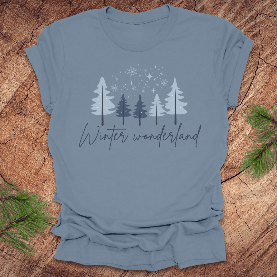 Steel Blue t-shirt with 'Winter wonderland' text and trees with snow design on a wooden surface
