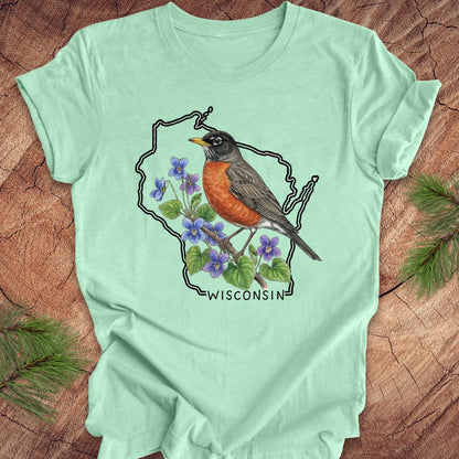 Mint green t-shirt with wisconsin outline, a robin and floral design on a wooden surface