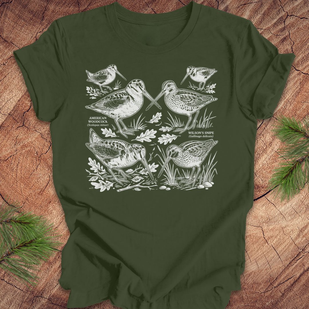 Green t-shirt with woodcock and snipe illustrations on a wooden surface