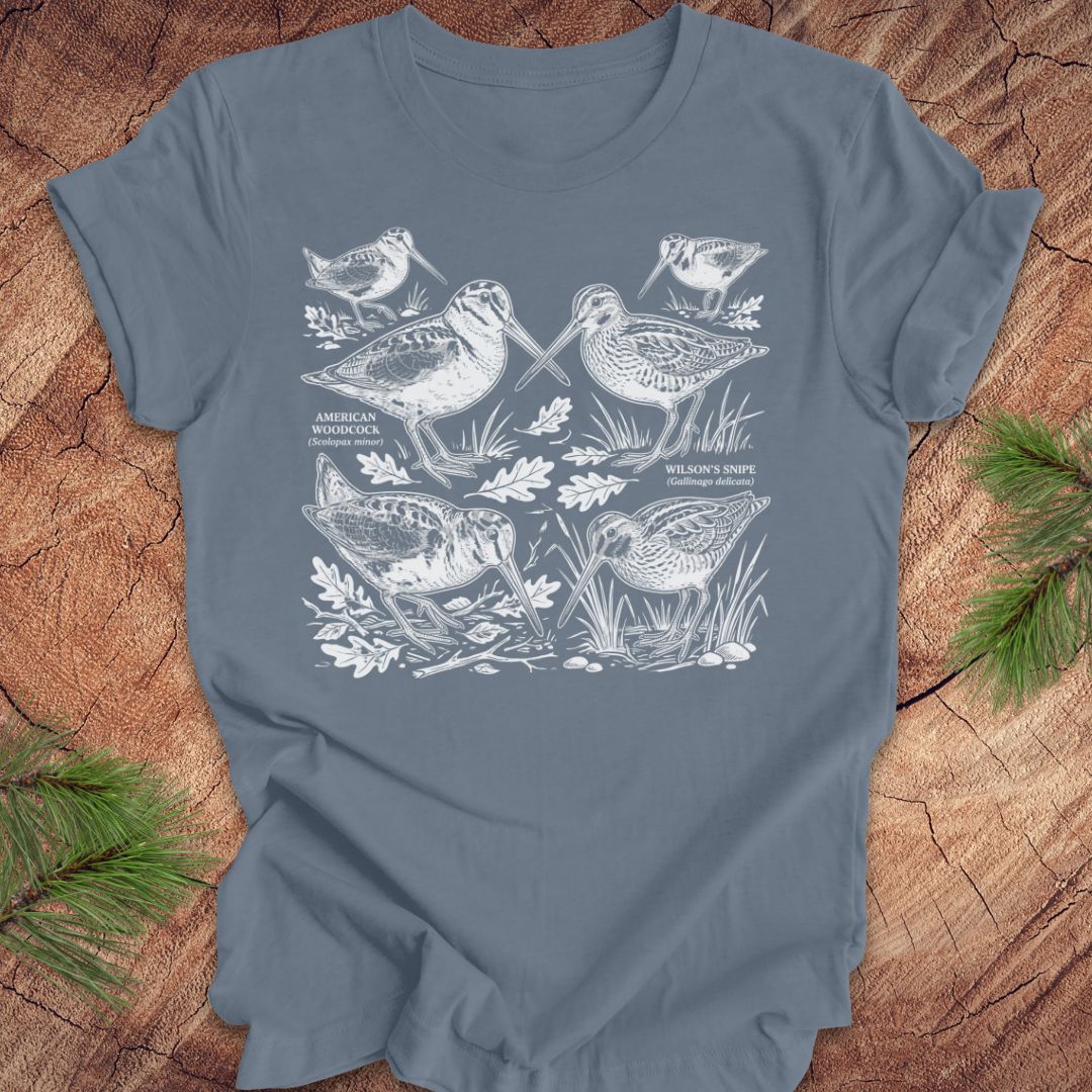 Steel blue t-shirt with woodcock and snipe illustrations on a wooden surface