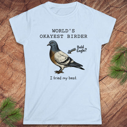 Light blue t-shirt with a pigeon graphic and text on a wooden surface