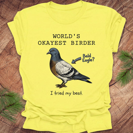 Yellow t-shirt with a pigeon graphic and text on a wooden surface