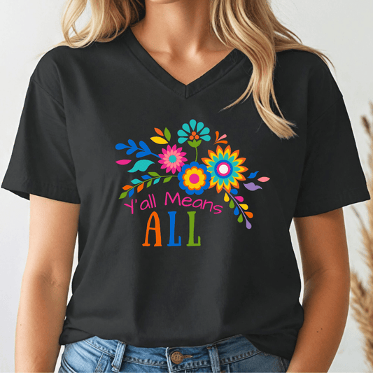 Person wearing a black v-neck t-shirt with colorful floral design and text, 'Y'all Means All'.