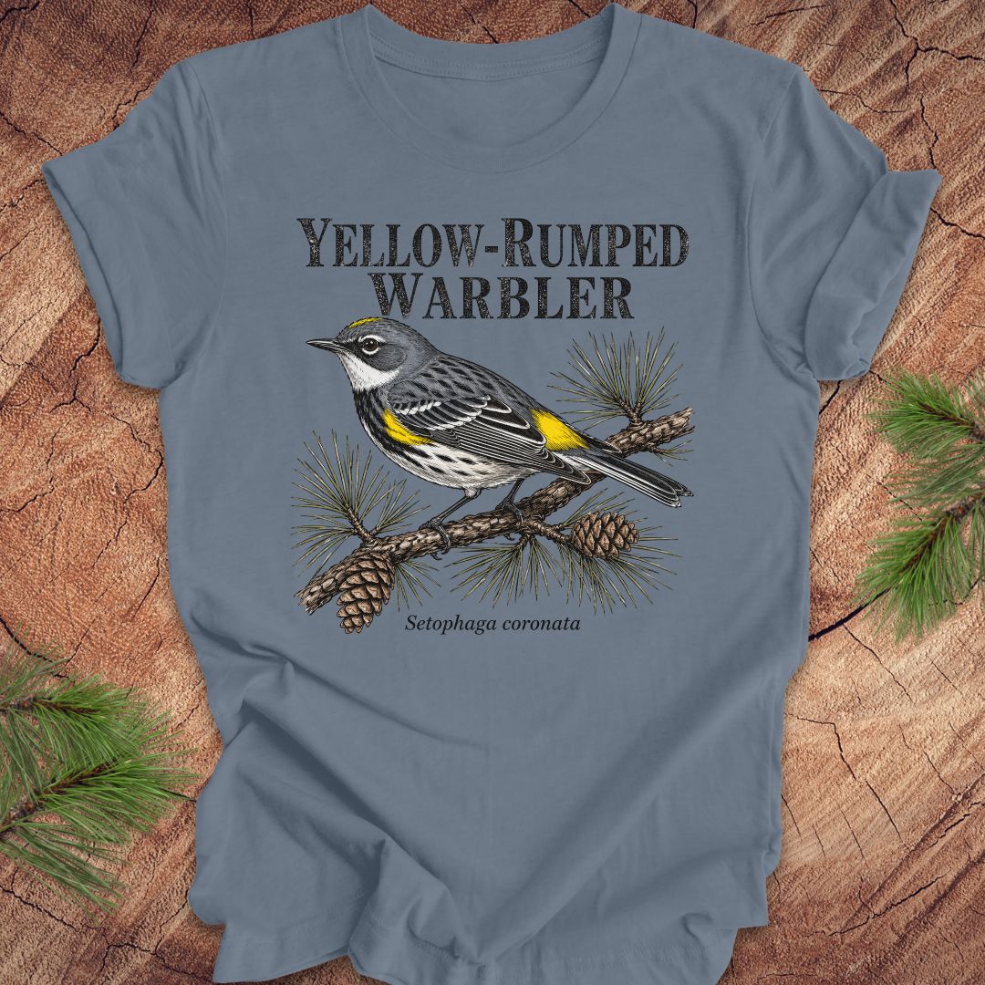 Blue t-shirt with yellow-rumped warbler graphic and text on a wooden surface.