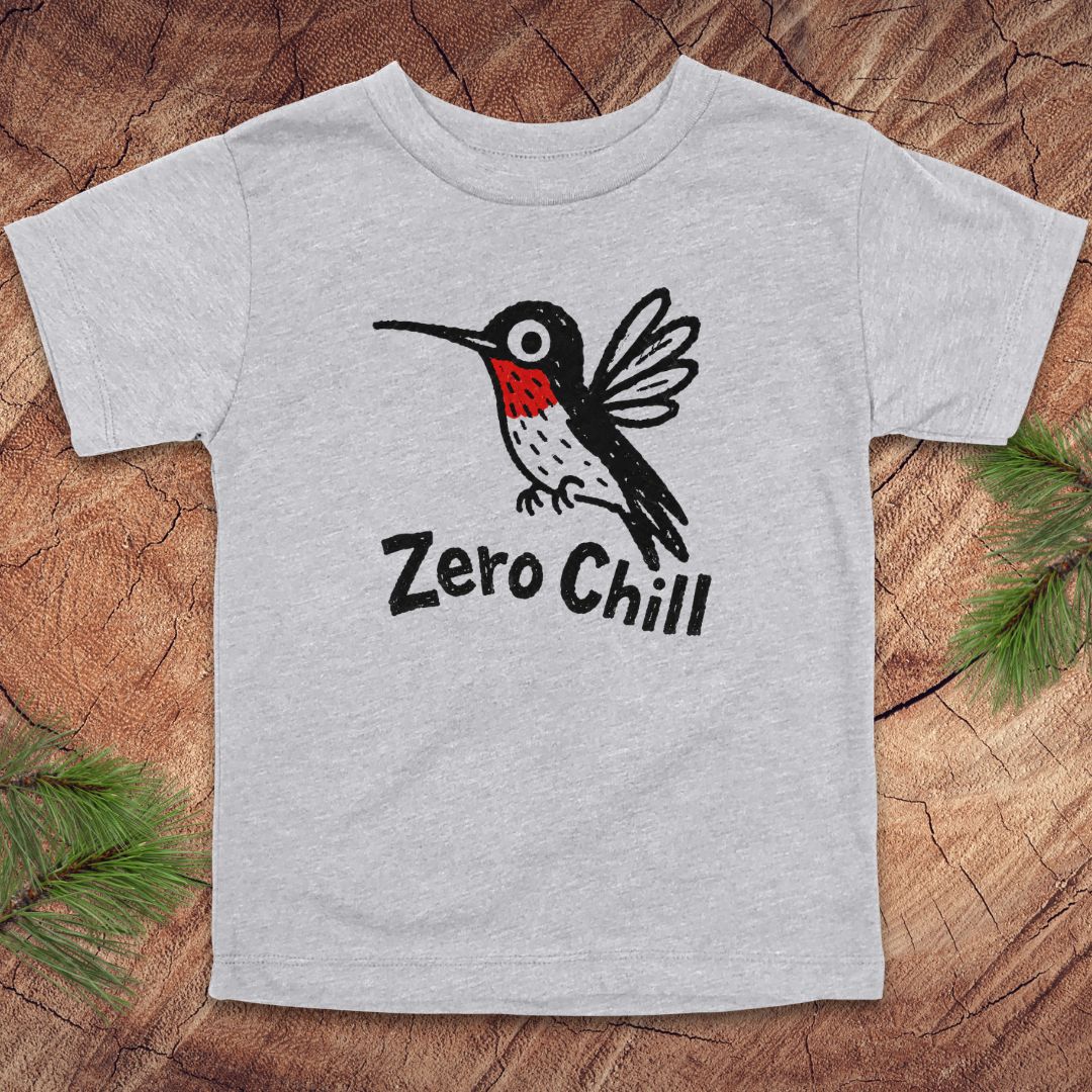 Gray t-shirt with a hummingbird graphic and 'Zero Chill' text on a wooden surface.