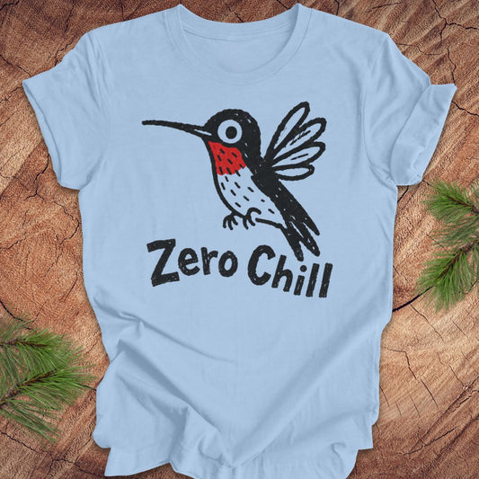 Light blue t-shirt with a black and red hummingbird graphic and 'Zero Chill' text on a wooden surface.