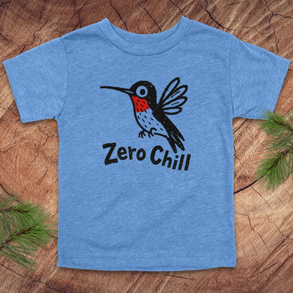 Blue t-shirt with a hummingbird graphic and 'Zero Chill' text on a wooden surface.