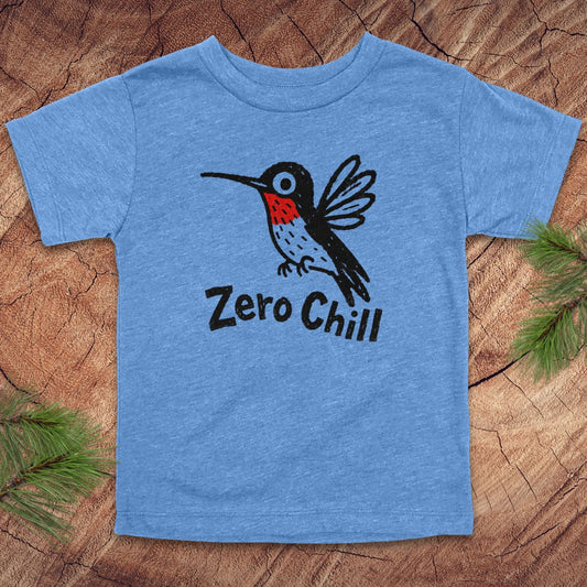 Blue t-shirt with a hummingbird graphic and 'Zero Chill' text on a wooden surface.
