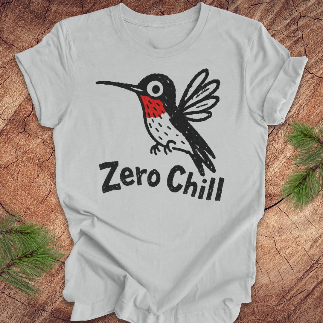 Gray t-shirt with a black and red hummingbird graphic and 'Zero Chill' text on a wooden surface.