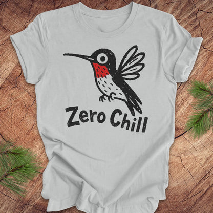 Gray t-shirt with a black and red hummingbird graphic and 'Zero Chill' text on a wooden surface.