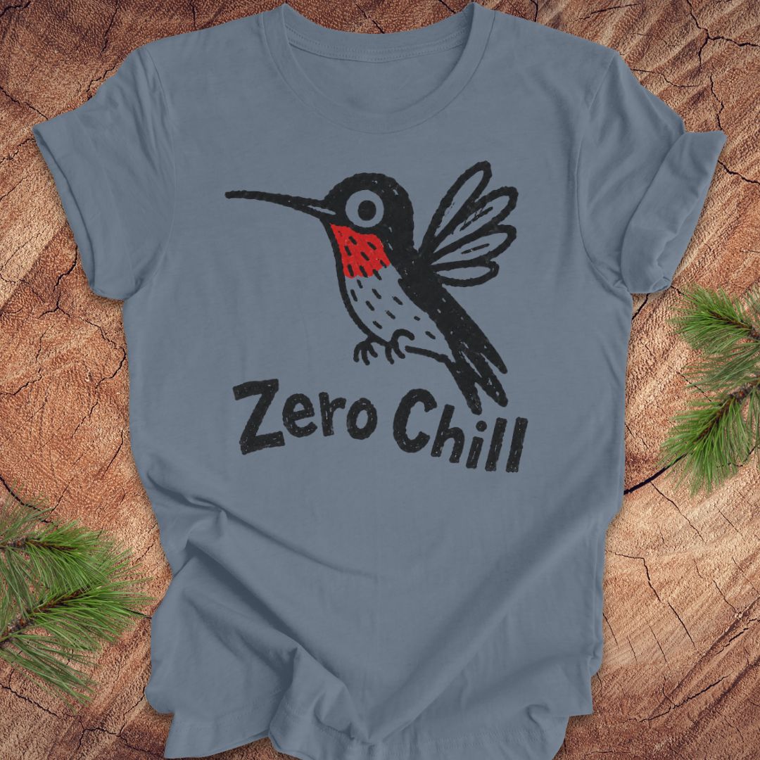 Blue t-shirt with a black and red hummingbird graphic and 'Zero Chill' text on a wooden surface.